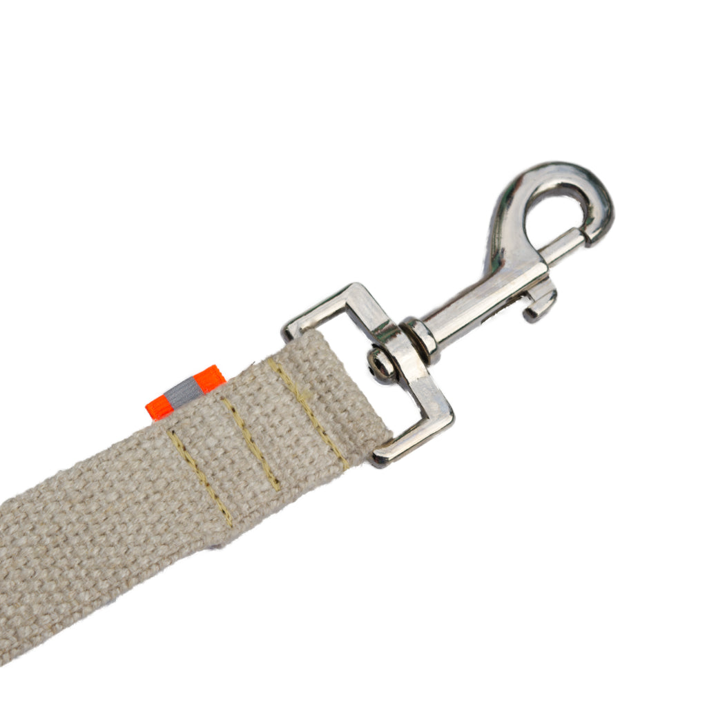 Tan undyed and nature hemp Canva leash splitter for dogs with fluorescent orange reflective tabs at all ends, yellow kevlar stitching and shiny silver metal hardware. pictured with white backdrop.