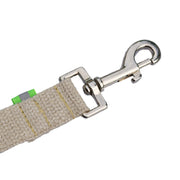 Tan undyed and nature hemp Canvas leash snap hook for dogs with fluorescent green reflective tabs at all ends, yellow kevlar stitching and shiny silver metal hardware. pictured with white backdrop.