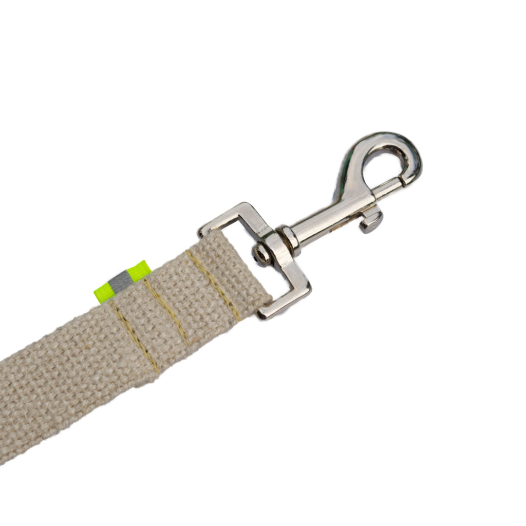 Tan undyed and nature hemp Canva leash splitter for dogs with fluorescent yellow reflective tabs at all ends, yellow kevlar stitching and shiny silver metal hardware. pictured with white backdrop.